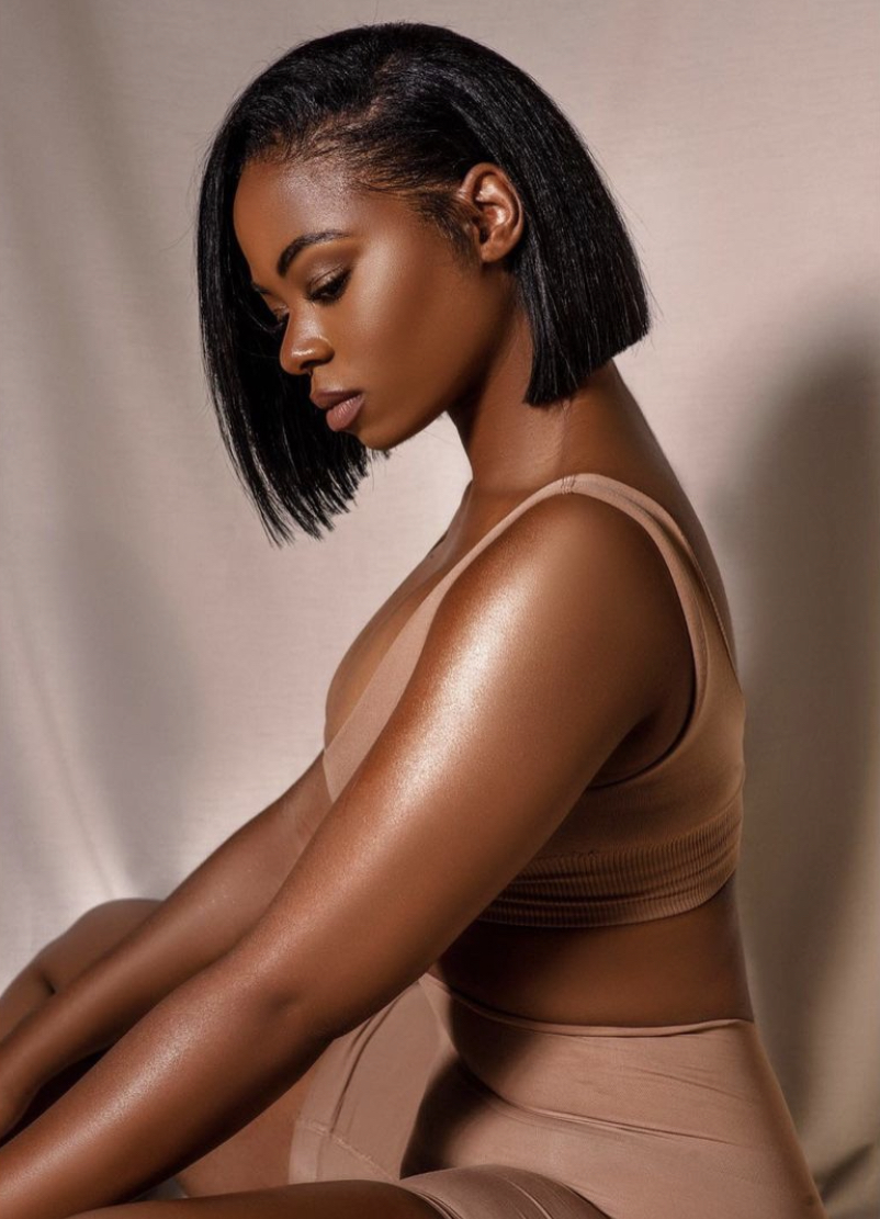 Editorial portrait with sleek bob and radiant, healthy skin in soft light