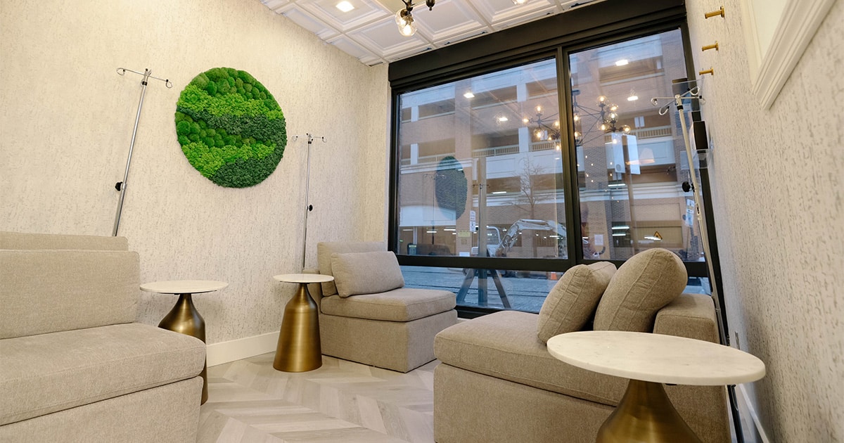Calm wellness recovery lounge with moss art and natural light
